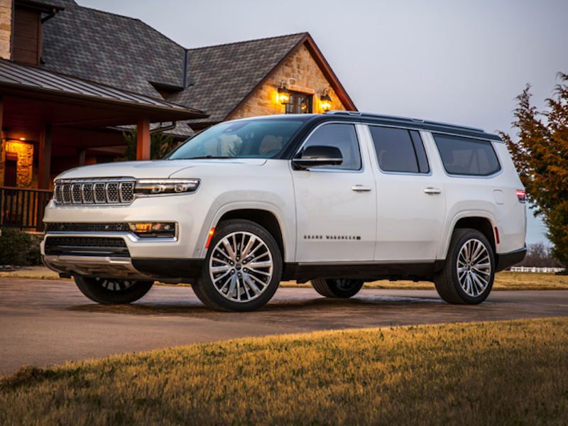 The 2023 Grand Wagoneer in a log cabin's driveway