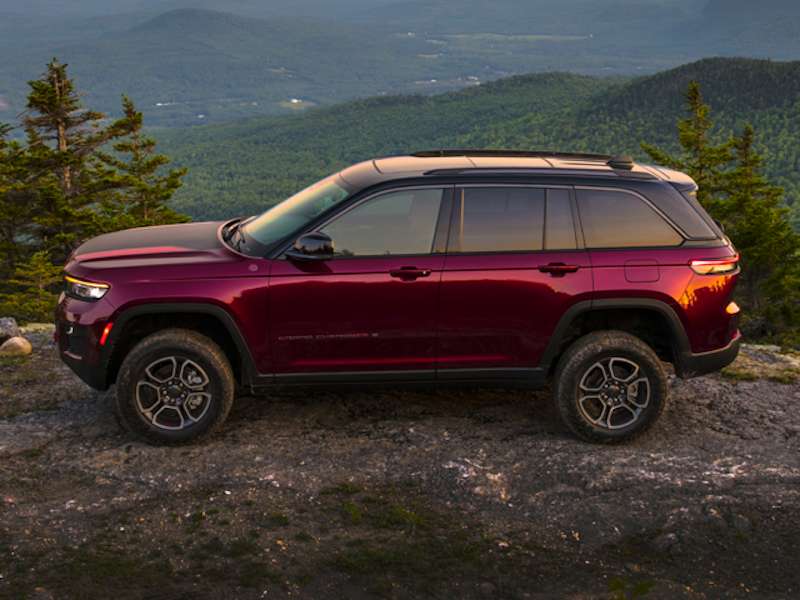 The 2024 Jeep Grand Cherokee atop a pine forest view in the mountains