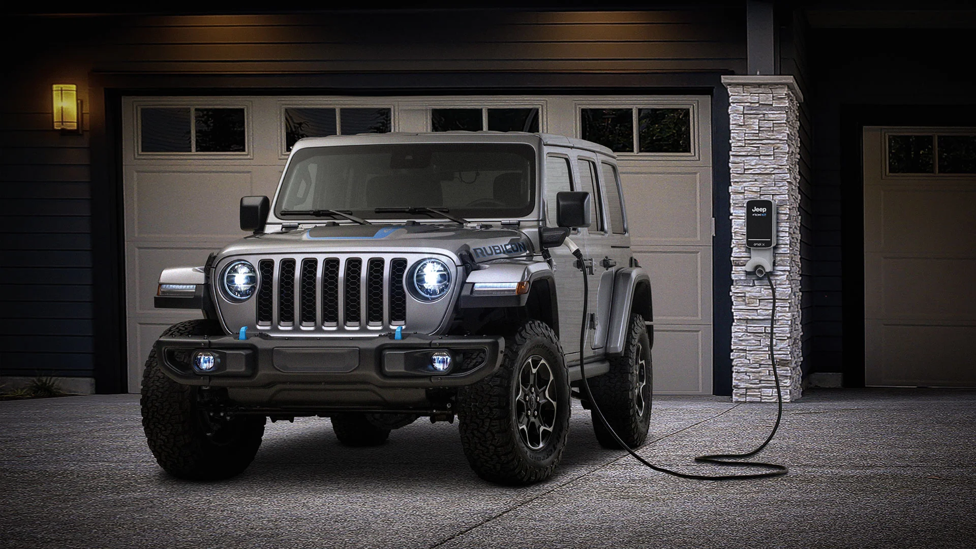 A Jeep Wrangler charging in the driveway